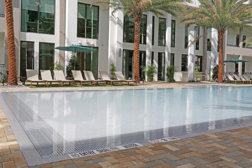 a swimming pool with a building in the background