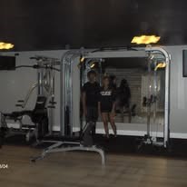 A woman is working out on a treadmill in a gym.