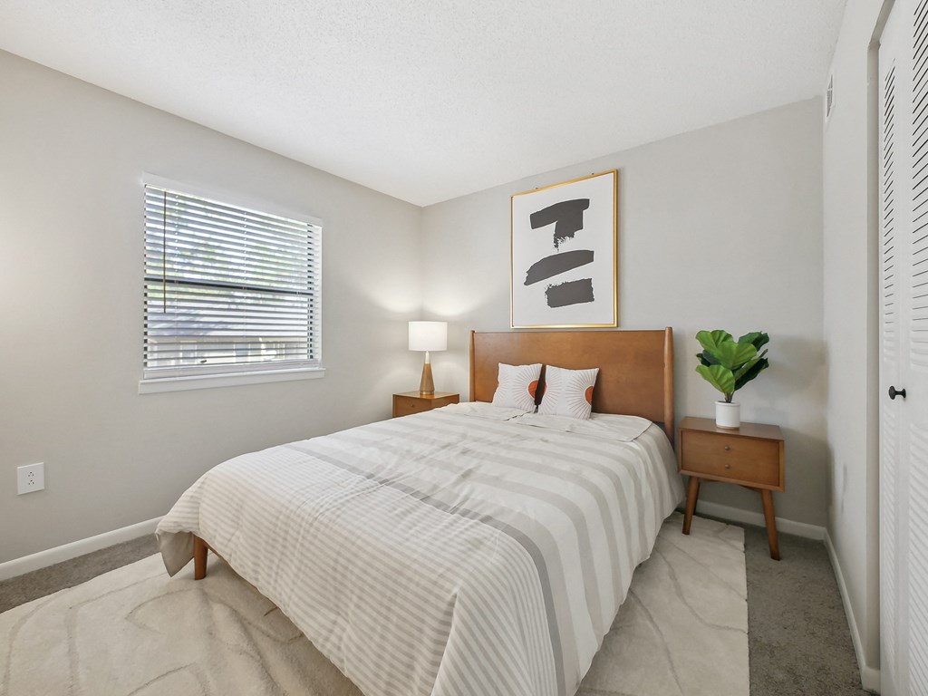 a bedroom with a bed and a window