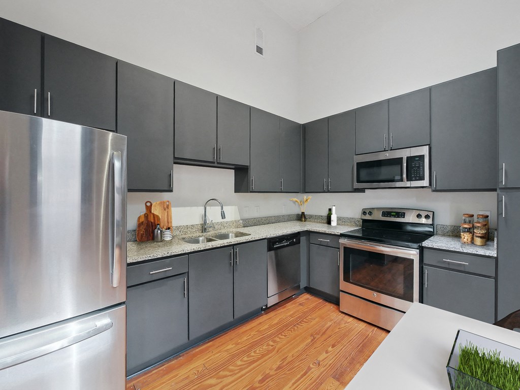 a kitchen with stainless steel appliances and gray cabinets