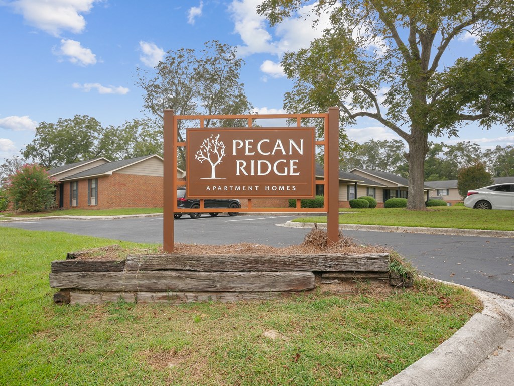 a sign apartment homes in front of a parking lot