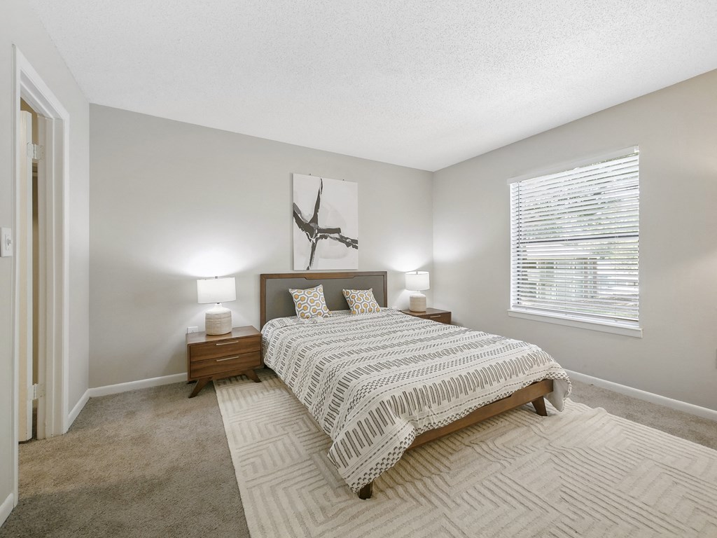 a bedroom with a bed and a window