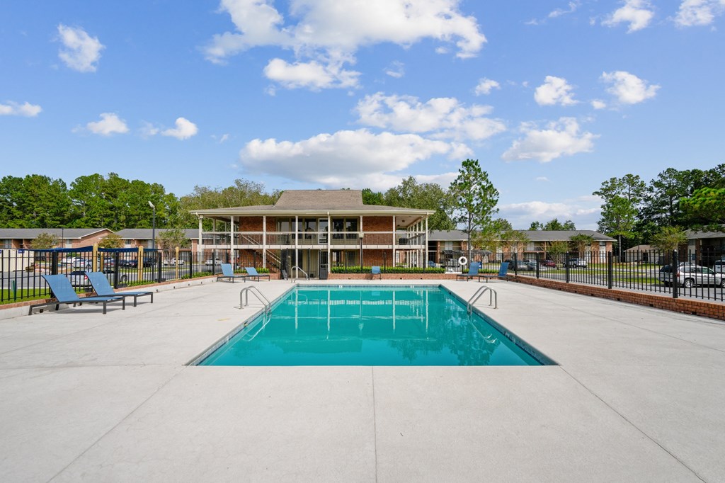 a swimming pool with a building in the background