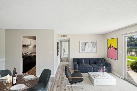 a living room with a couch and a table and chairs