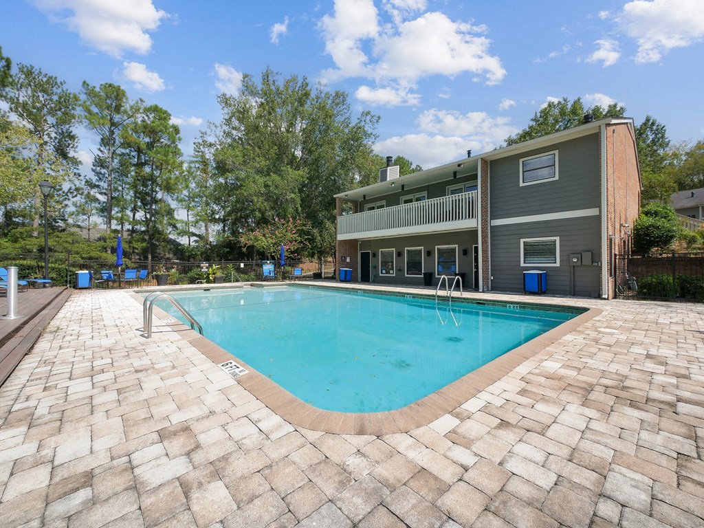 a swimming pool with a house in the background