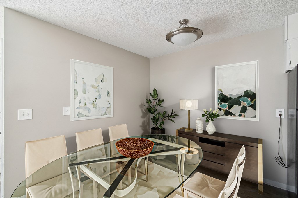 an image of a dining room with a glass table and chairs