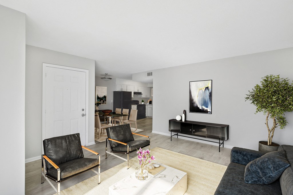 a living room with a couch and chairs and a table