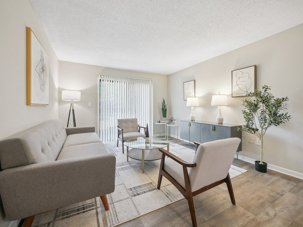a living room with couches and chairs and a glass table