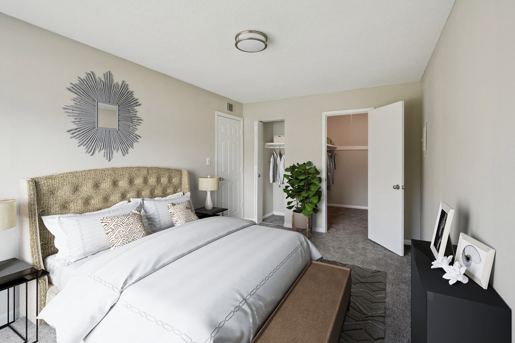 a bedroom with a large bed and a closet