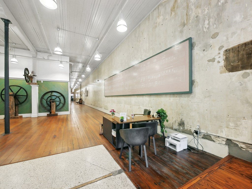 a conference room with a desk and chairs and a chalkboard on the wall