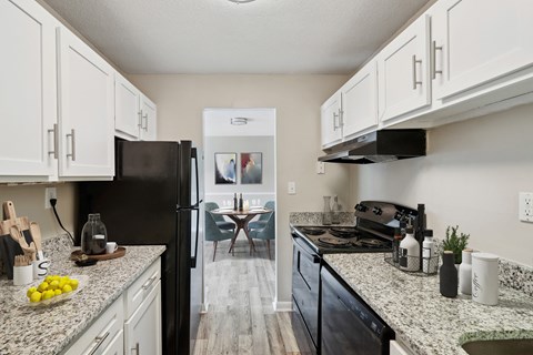 the preserve at ballantyne commons modern kitchen with granite counter tops and black appliances