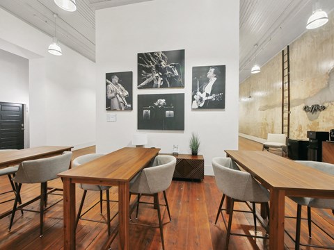 a dining room with tables and chairs and pictures on the wall