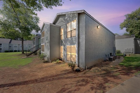 A modern house with a grey exterior and a large window.