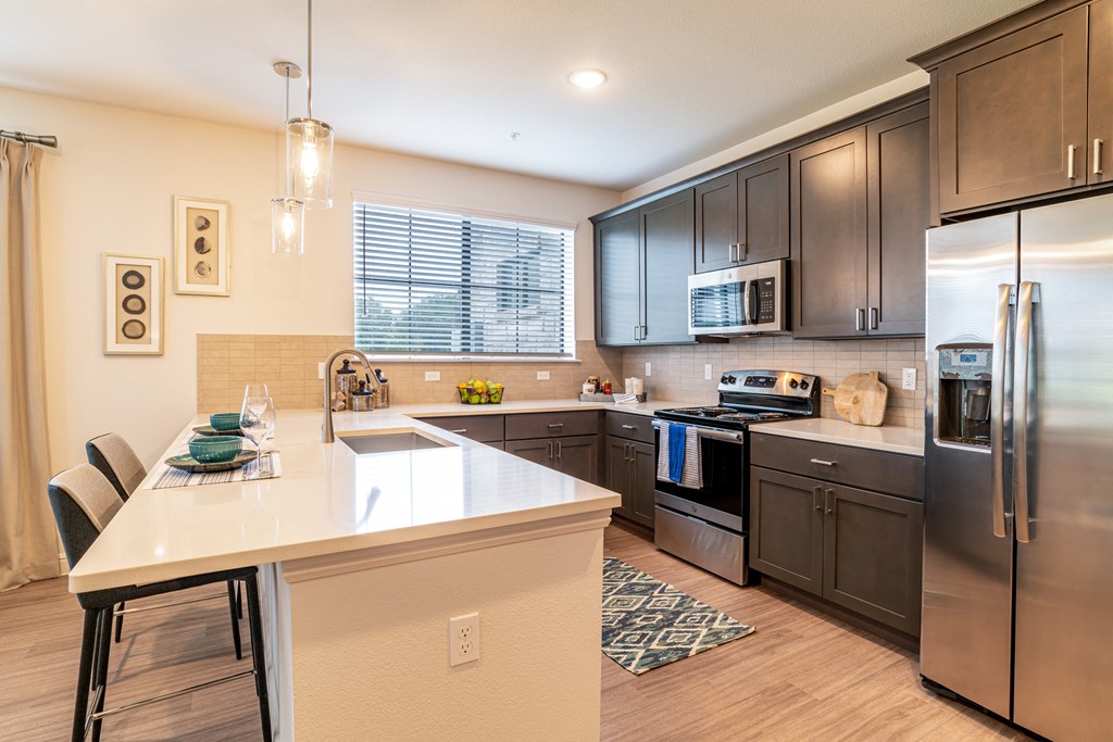 a kitchen with stainless steel appliances and a white counter top