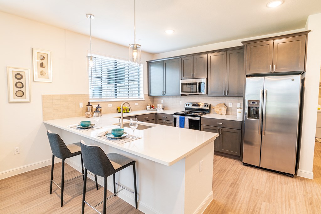 a kitchen with stainless steel appliances and a white counter top