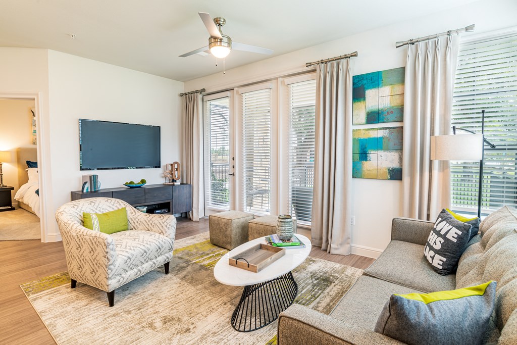 a living room with a couch and a chair and a television