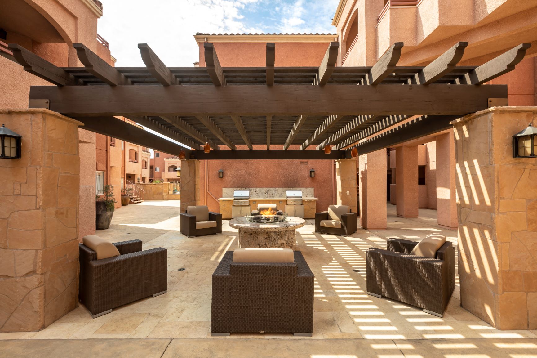 Apartments in Burbank, CA -  Pergola and Lit Fire Pit with Seating and view of Outdoor Grilling Area scott villa