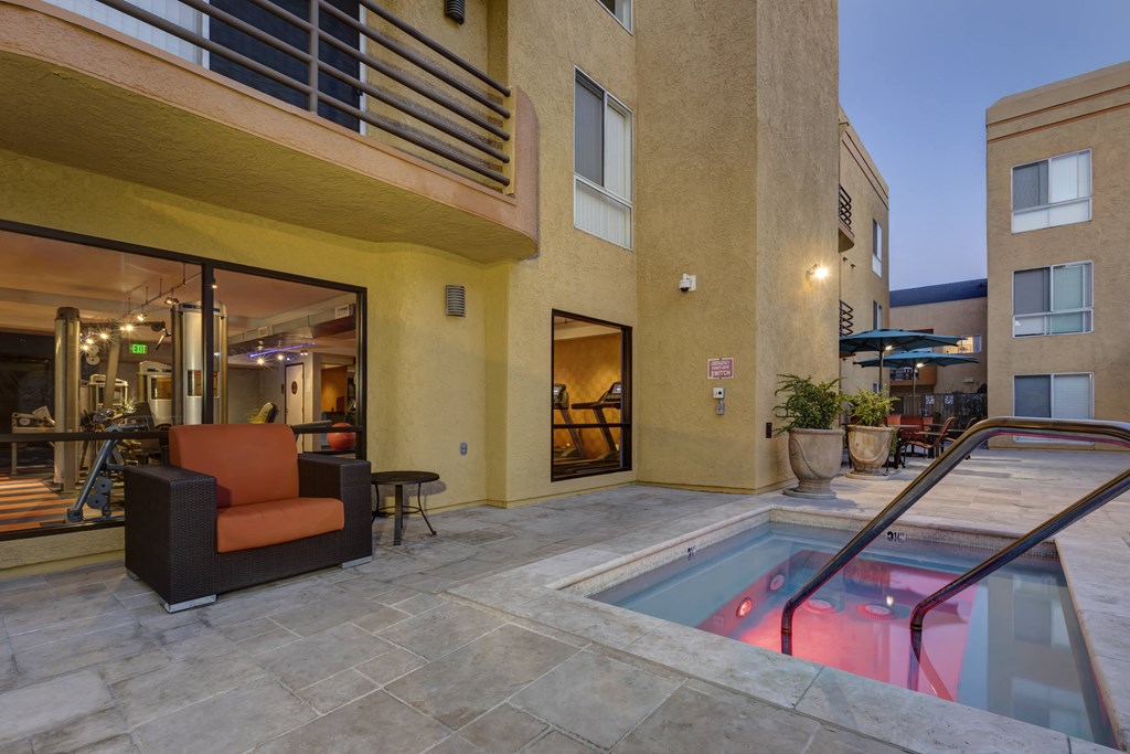 Apartments in Burbank, CA - Jacuzzi and Patio Area with Seating Lit Up at Night
