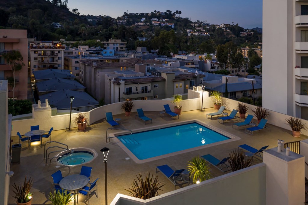 Apartments in Hollywood, CA - Elevated Night Time View of Pool, Jacuzzi, Patio with Lounge Chairs and Tables with view of  Surrounding Areas summit.