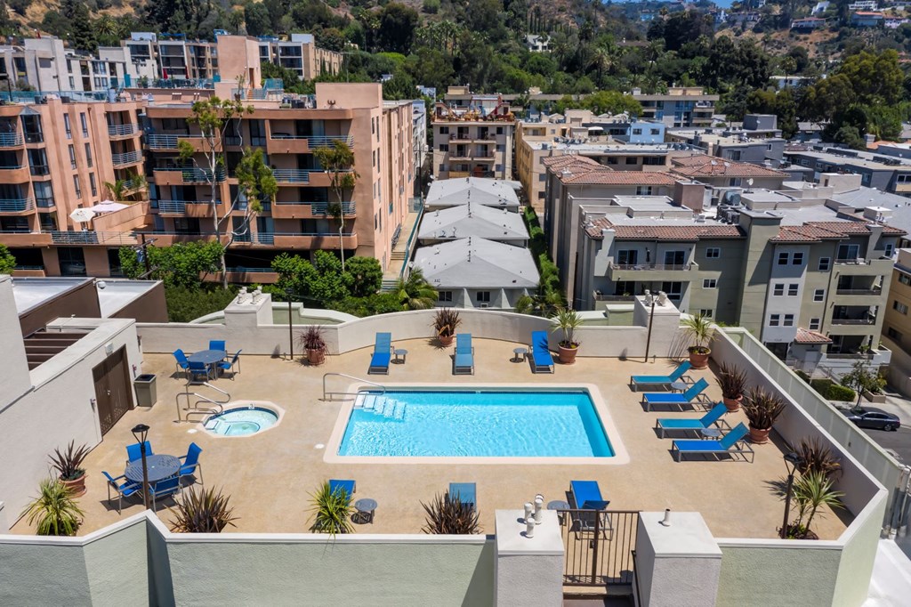 Apartments in Hollywood, CA - Elevated View of Pool, Jacuzzi, Patio with Lounge Chairs and Tables with view of  Surrounding Areas summit
