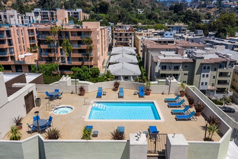 Apartments in Hollywood, CA - Elevated View of Pool, Jacuzzi, Patio with Lounge Chairs and Tables with view of  Surrounding Areas summit
