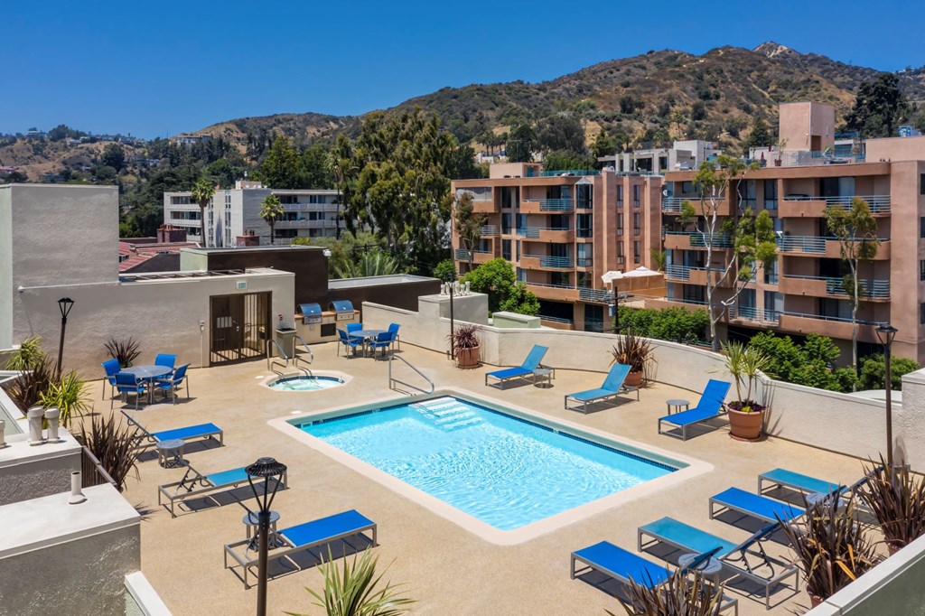 Apartments in Hollywood, CA - Elevated View of Pool, Jacuzzi, Patio with Lounge Chairs and Tables with view of Grilling Area and Surrounding Areas summit