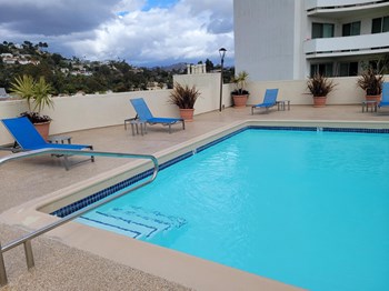 Apartments in Hollywood, CA - Pool, Patio with Lounge Chairs and Tables with view of Mountain side - Photo Gallery 10