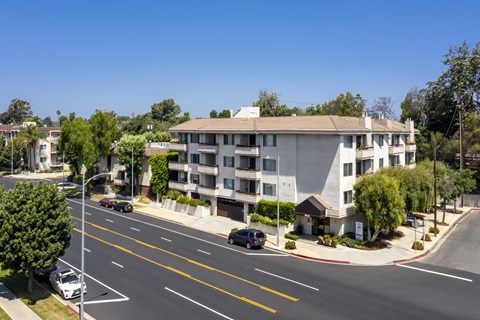 an aerial view of an apartment building on a city street