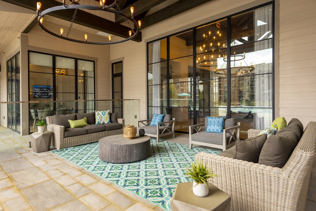 a patio area with couches chairs and a coffee table