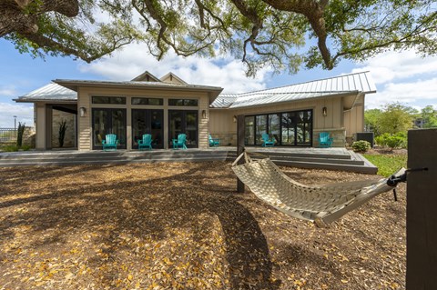 a hammock hanging in front of a house