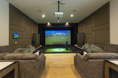 a home theater with couches and a large screen tv