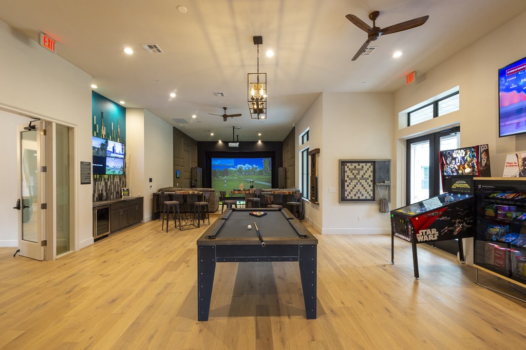 a game room with a pool table and a tv