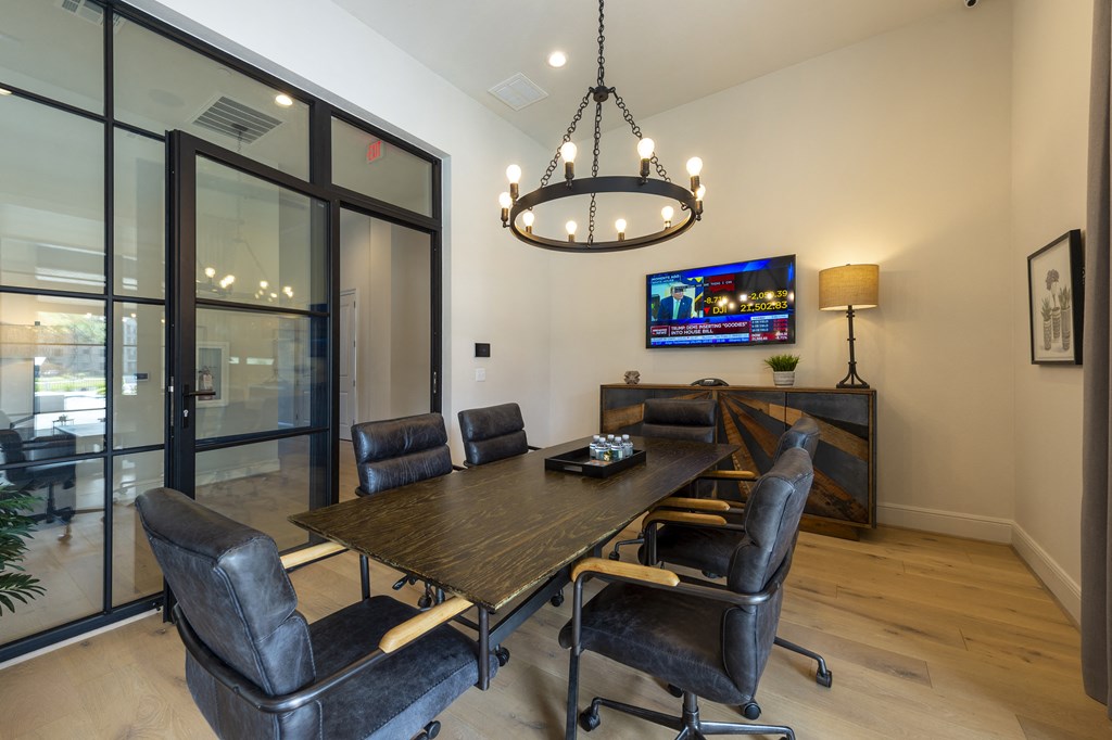 a dining room with a table and chairs and a tv