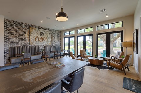 the lobby of a coffee shop with a large table and chairs