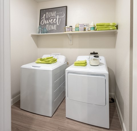 a laundry room with two washes and a dryer in a home sweet home