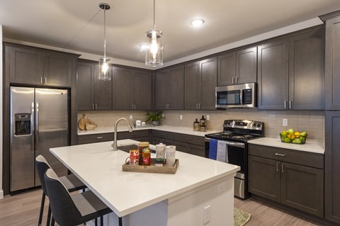 create a modern kitchen with dark cabinets and white counter tops