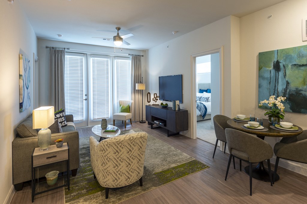a living room and dining room with a table and chairs