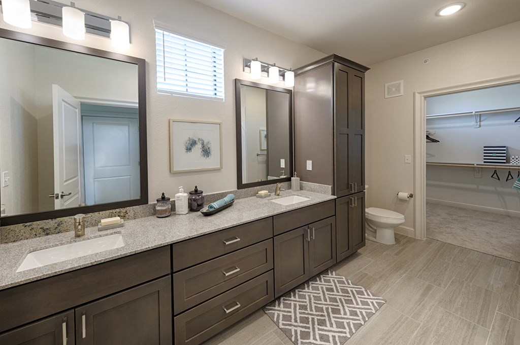 a large bathroom with two sinks and two mirrors