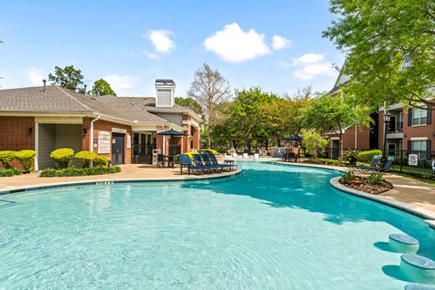 A swimming pool in a residential area with a building in the background.
