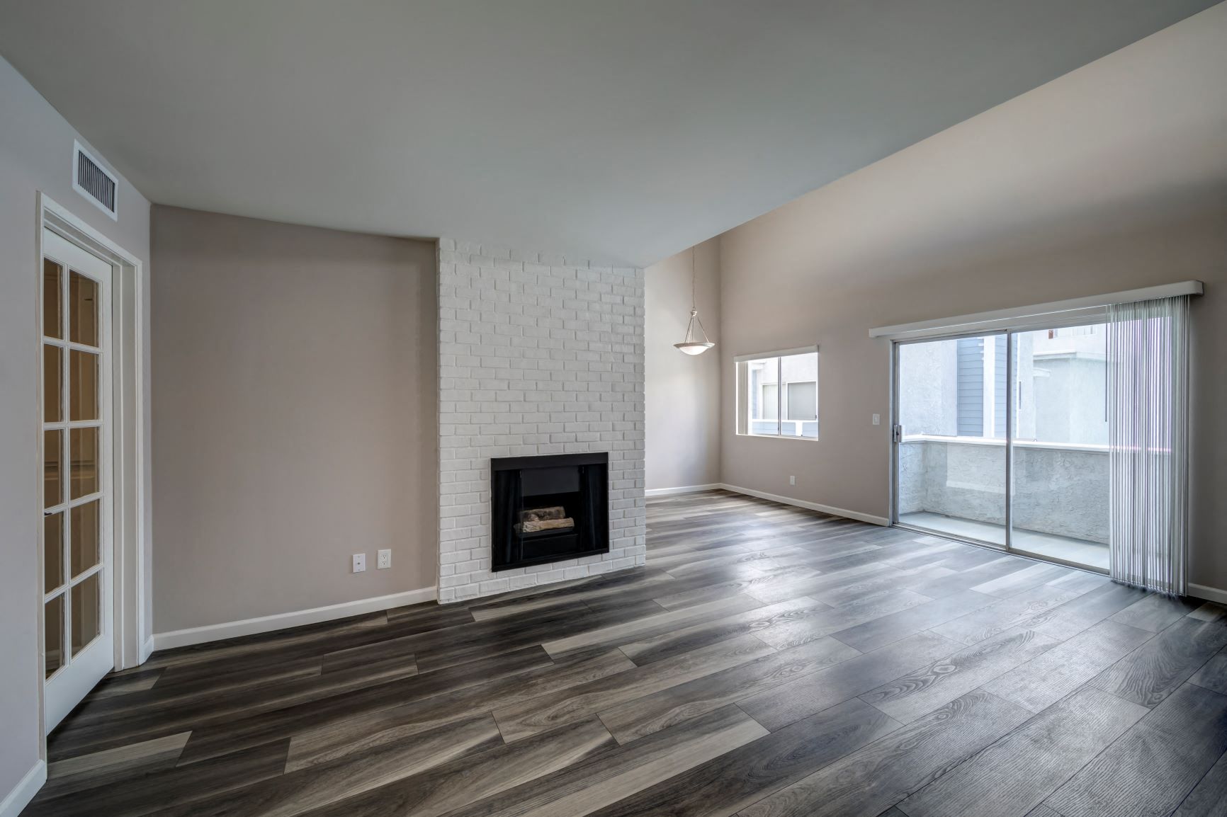 One Bedroom Apartments in Encino, CA Apartment Living Room with Fireplace, Dining Room, and French Door