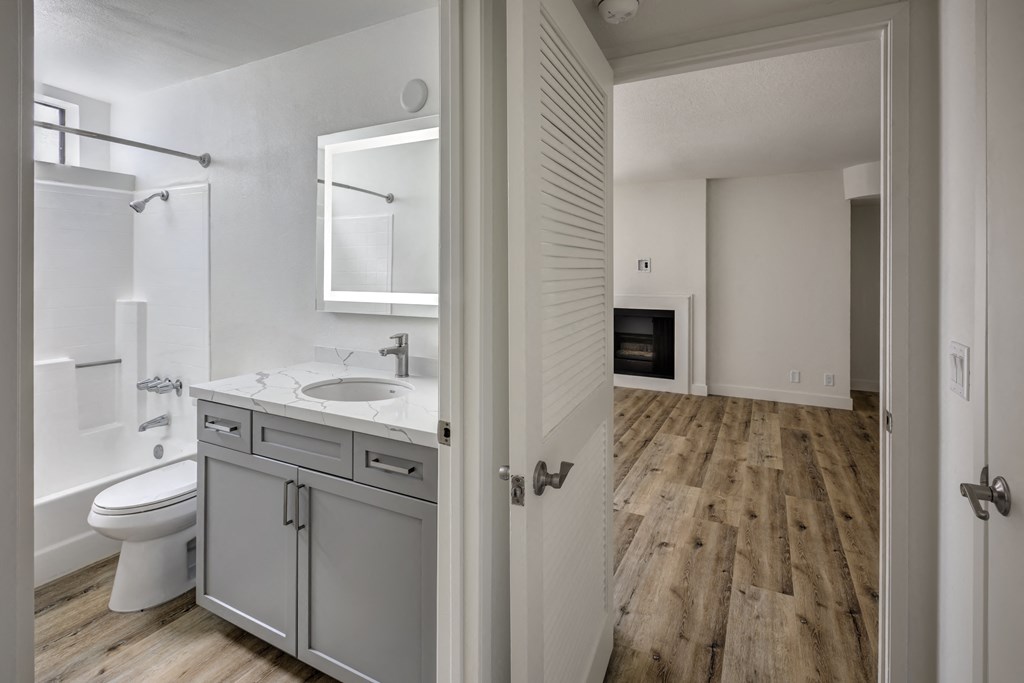 One Bedroom Apartments in Sherman Oaks, CA - Interior View of Bathroom and Living Room with Fireplace