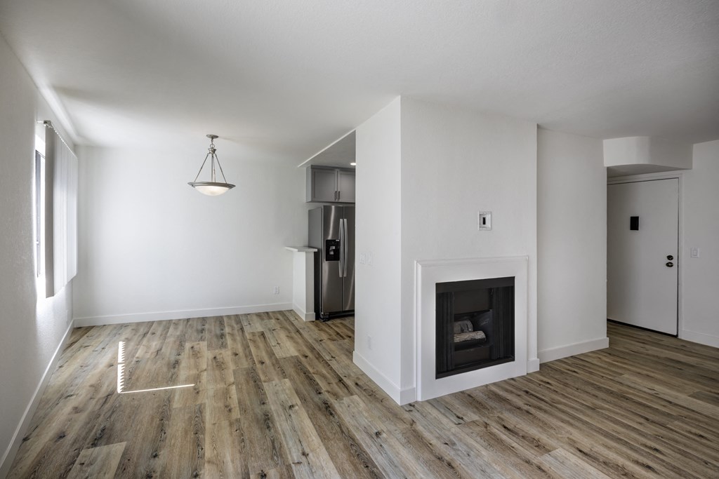 One Bedroom Apartments in Sherman Oaks, CA - Interior View of Entryway, Living Room with Fireplace, Dining Room and Kitchen Refrigerator