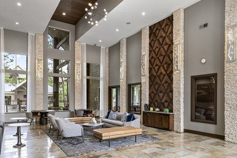 A modern living room with a large grey sofa and a wooden coffee table.