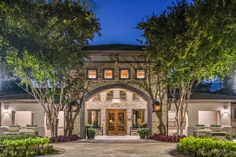 A large house with a stone facade and a large front door.