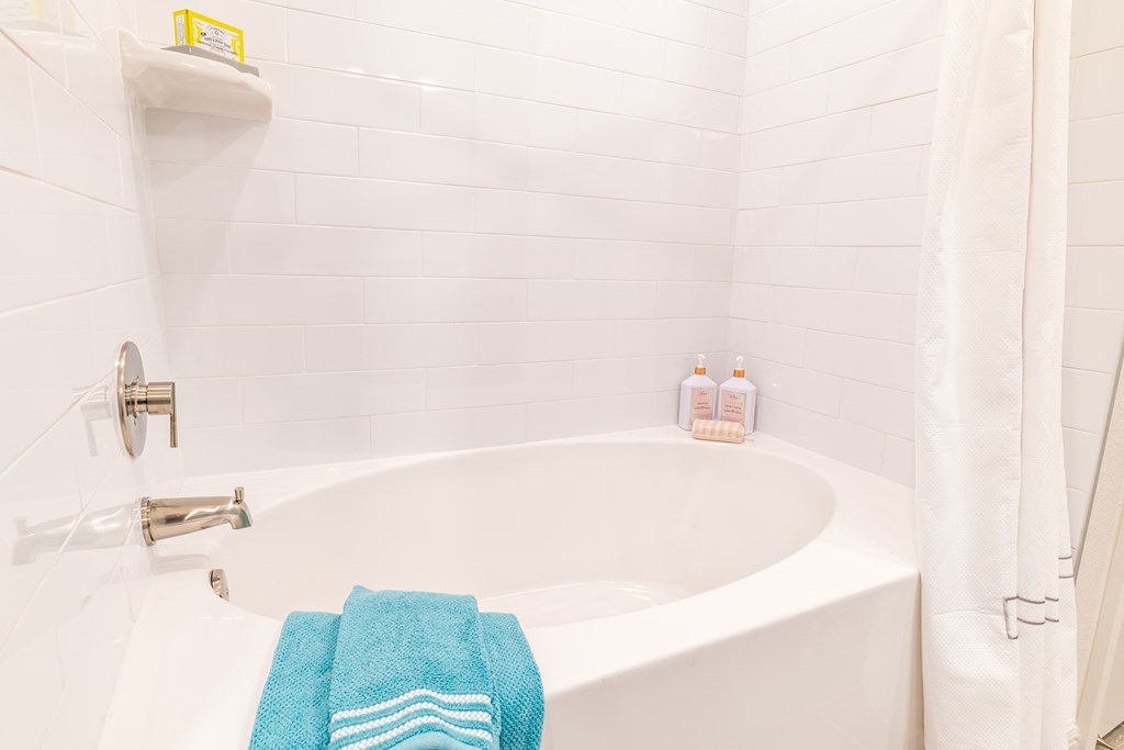 a bathroom with a bath tub and a towel