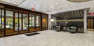a lobby with two chairs and a table - Photo Gallery 3
