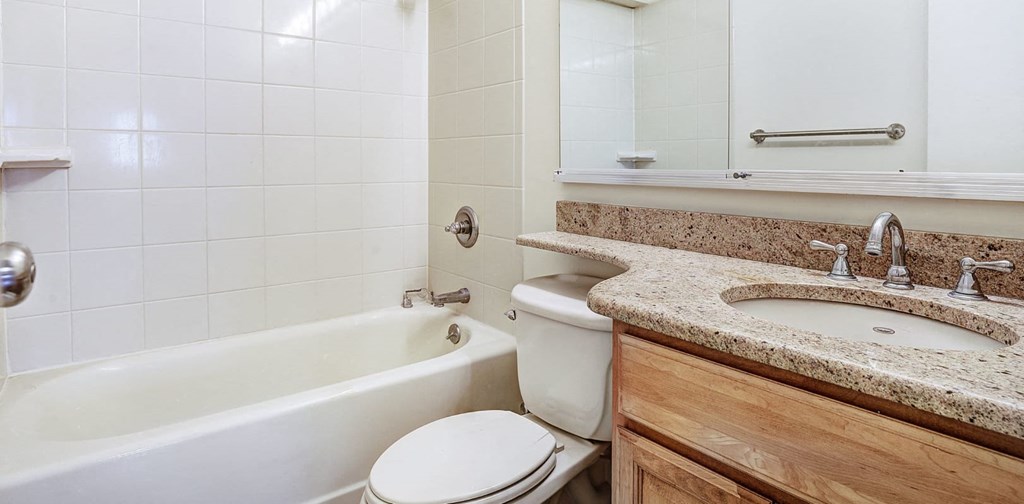 a bathroom with a sink toilet and bathtub at The Ivanhoe Apartments, Hackensack, New Jersey