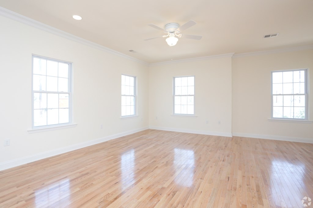 an empty room with a ceiling fan and three windows at Greenway Village Apartments, New Jersey, 08840