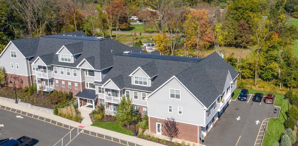a large house with a gray roof at Zephyr Ridge Apartment Homes, Cedar Grove, NJ