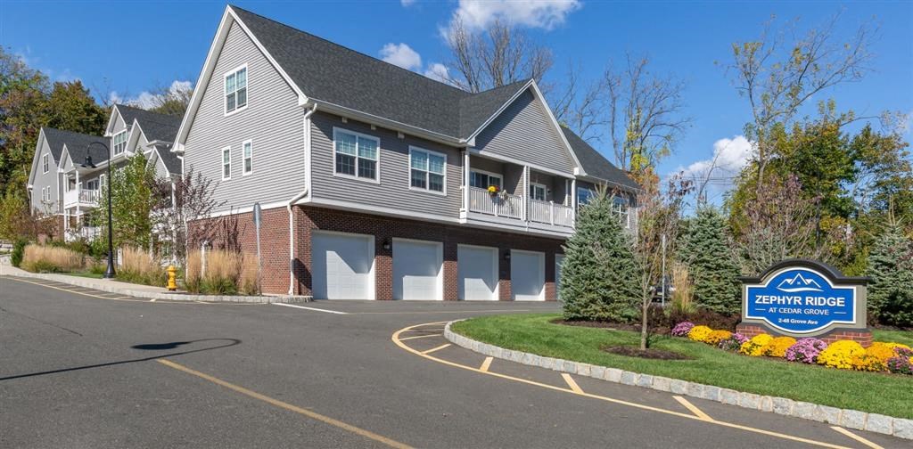 a house with a parking lot and a sign in front of it at Zephyr Ridge Apartment Homes, New Jersey, 07009
